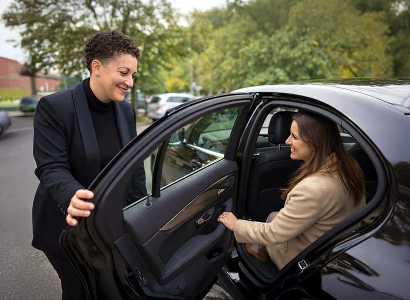 Un particulier monte dans une voiture VTC.